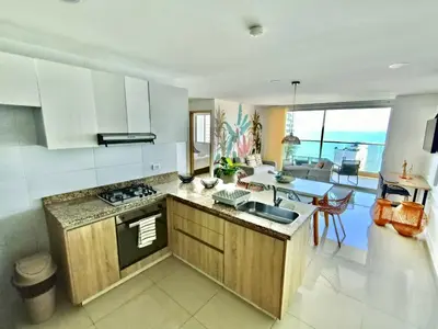 a kitchen with white cabinets and a counter top at New Apartments with great Sunsets near historic center and beach in Cartagena de Indias