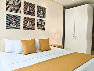 a bedroom with a large white bed with pillows at Morros 3 Apartamentos de Lujo in Cartagena de Indias