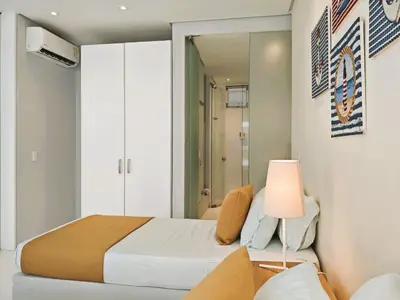 a bedroom with a bed with a lamp and a mirror at Morros 3 Apartamentos de Lujo in Cartagena de Indias
