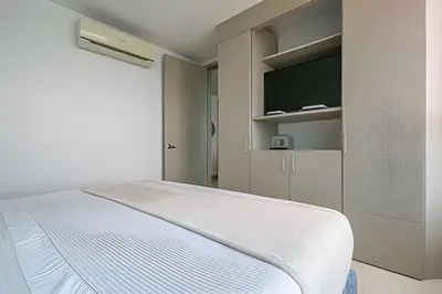 a bedroom with a bed and a flat screen tv at Laurdhomes Palmetto Beach Sea View, for working in Cartagena de Indias