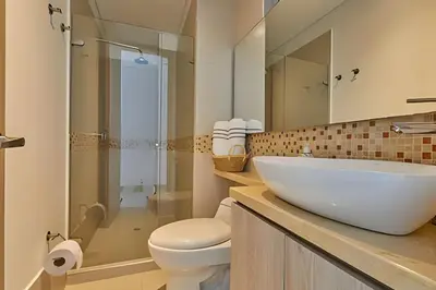 a bathroom with a sink and a toilet and a shower at Laurdhomes Palmetto Beach Sea View, for working in Cartagena de Indias