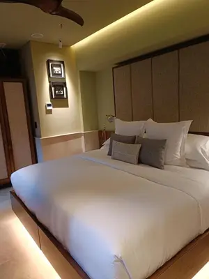 a large white bed in a bedroom with lights at Hotel Casona del Porvenir in Cartagena de Indias