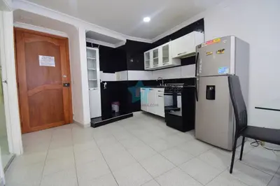 a kitchen with black and white appliances and a brown door at apartamento con vista piso 20 in Cartagena de Indias