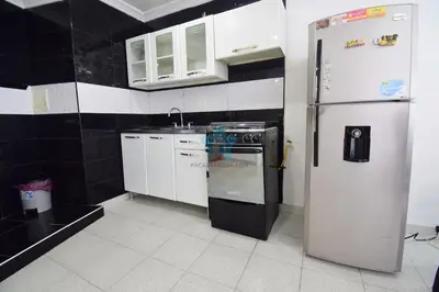 a small kitchen with a refrigerator and a sink at apartamento con vista piso 20 in Cartagena de Indias