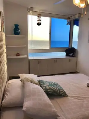 a bedroom with a bed and a large window at Hermoso apartamento con vista al mar in Cartagena de Indias