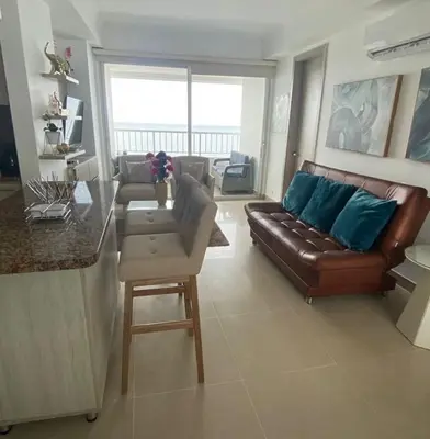 a living room with a leather couch and a table at apartamento en bocagrande in Cartagena de Indias