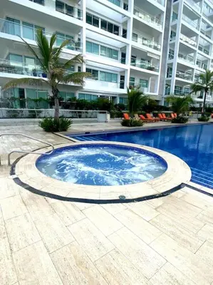 a large swimming pool in front of a large building at Hermoso apartamento familiar /acceso directo a la playa. Morros 3 in Cartagena de Indias
