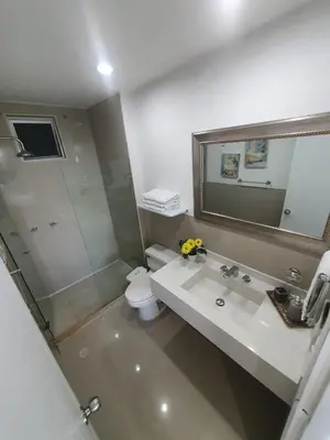 a bathroom with a sink and a toilet and a mirror at Espectacular apartamento Morros Epic Cartagena, Acceso directo a la playa in Cartagena de Indias