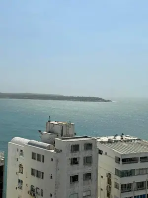 a white building next to the ocean with a body of water at CARTAGENA LA FANTASTICA in Cartagena de Indias