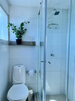 a bathroom with a toilet and a glass shower at CARTAGENA LA FANTASTICA in Cartagena de Indias