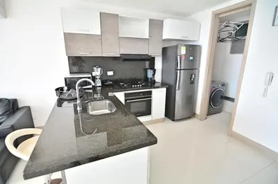 a kitchen with a sink and a refrigerator at Toscana Suite 2205 in Cartagena de Indias