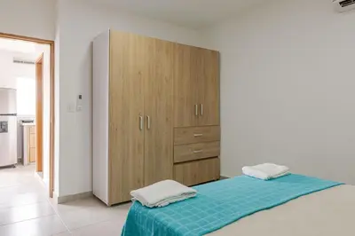 a bedroom with a bed with a wooden cabinet at Casa Bacoba in Santa Marta