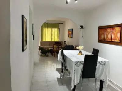 a dining room with a white table and chairs at Casa Encanto Cartagena Colombia in Cartagena de Indias