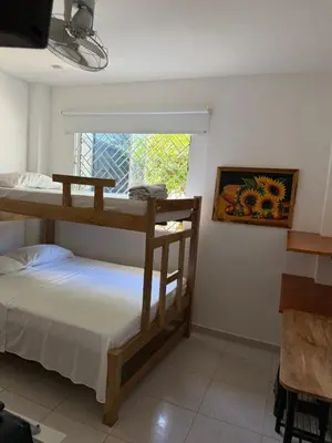 two bunk beds in a room with a window at Apartaestudio Playa Linda 101 in Coveñas