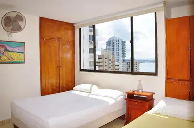 a bedroom with two beds and a large window at II-Nice and cozy 2 bedroom Apt BOCAGRANDE in Cartagena de Indias