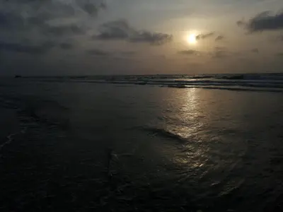 a sunset on a beach with the ocean at LA GAITERA Cabaña in Moñitos