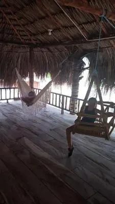 two people in a hammock in a straw hut at LA GAITERA Cabaña in Moñitos