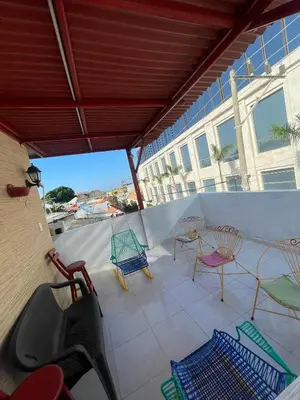 a patio with chairs and tables on a balcony at Casa 39-33 in Cartagena de Indias