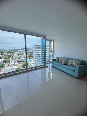 a living room with a couch and a large window at Pent House 450 mts 360 front ocean view playa azul in Cartagena de Indias