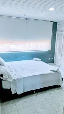a large bed in a room with a large window at Vista Playa in Cartagena de Indias