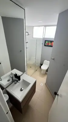 a bathroom with a sink and a toilet and a mirror at Vista Playa in Cartagena de Indias