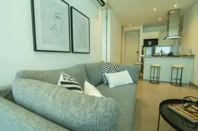 a living room with a couch with pillows on it at Suite de lujo Distrito 90 in Barranquilla