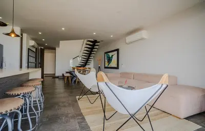 a living room with a couch and some chairs at Penthouse en zona norte cartagena luxury con 3 habitaciones y excelente wifi in Cartagena de Indias