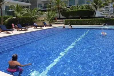 a group of people playing in a large swimming pool at Apartamento Morros vitri 214 zona norte in Cartagena de Indias