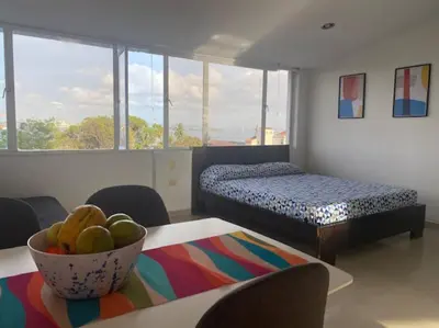 a room with a bed and a bowl of fruit on a table at Ubicación increíble! cerca del centro y del mar in Cartagena de Indias