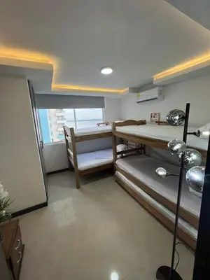 a room with three bunk beds and a window at Apartamento Vacacional Cartagena in Cartagena de Indias