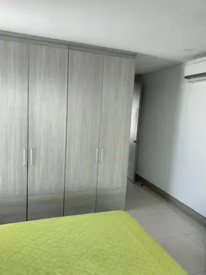 a room with gray cabinets and a green rug at Apartamento El Laguito Cartagena in Cartagena de Indias