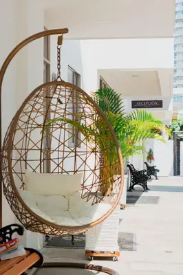 a hanging rattan swing in a room at Hotel El Marqués De Manga in Cartagena de Indias