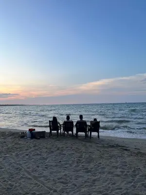 a group of people sitting in chairs on the beach at Cabaña en coveñas in Coveñas