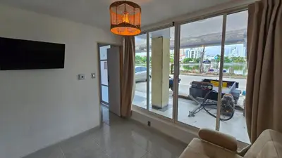 a living room with a large window and a television at Oceanfront loft in high level neighborhood in Cartagena de Indias