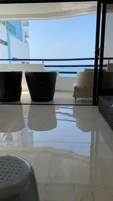 a living room with a table and chairs and a large window at Modern Duplex Balcony Sea View Mr8 in Cartagena de Indias