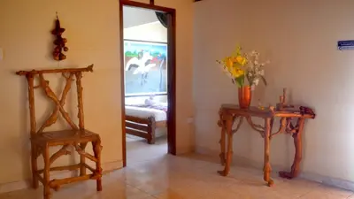 a room with two wooden tables and a mirror at Hotel Costa Mar Coveñas in Coveñas