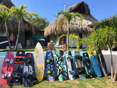 a bunch of surfboards lined up in front of a house at KokohauBungalows in Santa Veronica