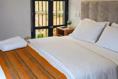 a bedroom with a large white bed and a window at Casa Lorenza Hotel in Cartagena de Indias