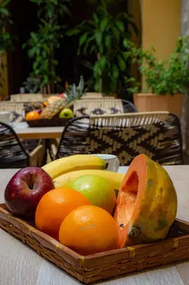 a wooden tray of fruit on a table at Casa Lorenza Hotel in Cartagena de Indias