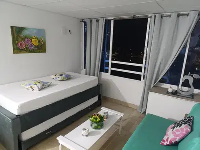a small room with a bed and a table at Excelente vista al mar in Cartagena de Indias