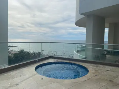 a swimming pool on a building with a view of the ocean at APARTAMENTO PALMETTO ELIPTIC Bocagrande in Cartagena de Indias