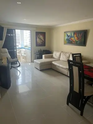 a living room with a white couch and chairs at Lindo Apartamento cerca al mar in Cartagena de Indias
