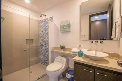 a bathroom with a toilet and a sink and a shower at Apartamento Bocagrande Vista al Mar Piso 21 in Cartagena de Indias