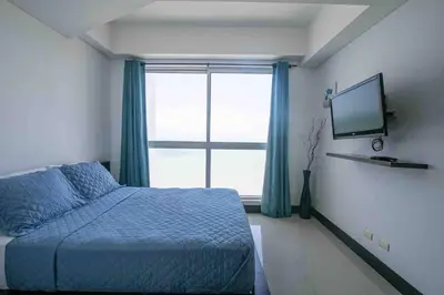 a bedroom with a bed and a large window at Apartamento Bocagrande Vista al Mar Piso 31 in Cartagena de Indias