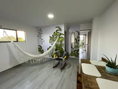 a living room with a hammock and plants at Apartamento Cómodo y encantador en cartagena in Cartagena de Indias