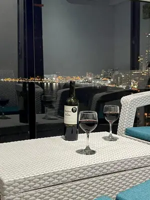 a bottle of wine sitting on a table with two glasses at Apartamento Cartagena con vista al mar in Cartagena de Indias