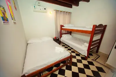 a room with two bunk beds and a checkered floor at Casa Hotel Marbella Beach in Cartagena de Indias