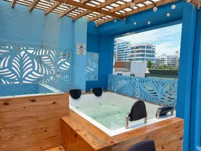 a jacuzzi tub in a room with blue walls at Avadia del Mar in Cartagena de Indias