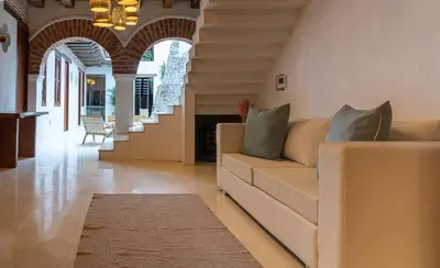 a living room with a couch and a fireplace at Hotel Voilá Getsemaní in Cartagena de Indias