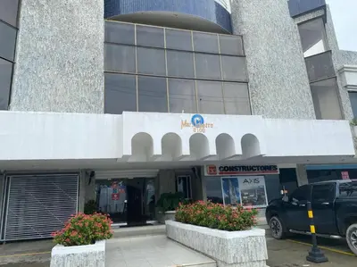 a building with a car parked in front of it at Apartamento , vista a la ciudad antigua y playa in Cartagena de Indias